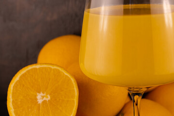 Juice in a glass and juicy oranges