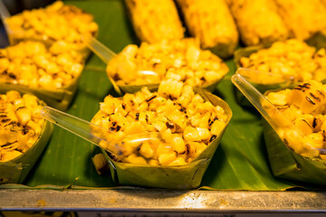 Sweet corn with butter grilled on the charcoal stove in the market.Thailand