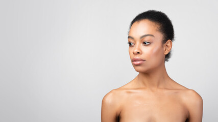 Fototapeta na wymiar Portrait Of Black Woman Looking Aside Posing Shirtless, Gray Background