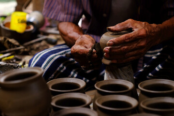 Fototapeta na wymiar Professional thai old man using mechanic pottery made earthenware at Koh Kret in Nonthaburi Thailand