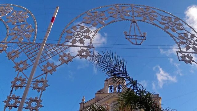 Street illuminations in front of the church for the patronal celebration. Marina di Camerota, Italy.