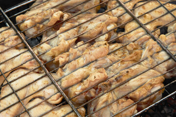 Chicken wings on grill, close-up. Cooking bbq chicken