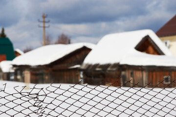 Fototapeta premium Cottage houses at winter countryside. Russian village houses