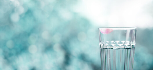 Woman Drinking Clean Water Concept. Red Lipstick on Glass. Blurred Nature Tree as background. Surreal Color Tone. Front View. Clean and Minimal with Empty for Copy Space