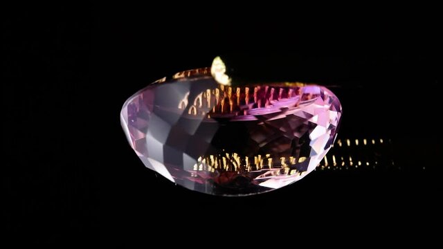 natural ametrine in the tweezers on the background