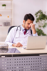 Young male doctor working in the clinic