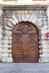 Fototapeta na wymiar Facade of a old door made of wood in Old Lyon France