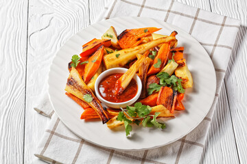 Fototapeta na wymiar Sunday roast dinner: roasted parsnip and carrot