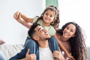 Fototapeta na wymiar Closeup Of Happy Arab Family Of Three Having Fun Together At Home