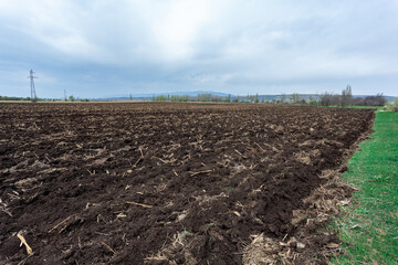 Agriculture plowed field. Black soil plowed. Landscape of farmland