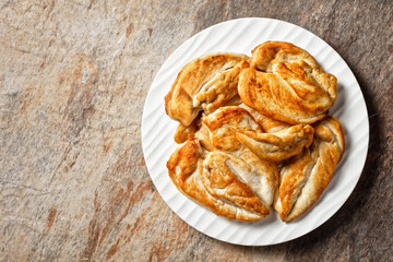 Roast Chicken breasts on a plate, top view