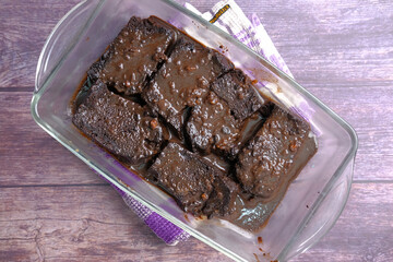 slice of homemade brownie on plate on table 