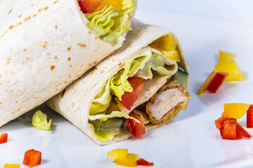 Stuffed tortilla with fresh vegetables and turkey meat. The food in the restaurant. Food styling and restaurant meal serving.