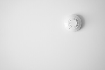 smoke detector sensor by fire alarm system for protect and detection object or safety equipment in smart home and building on white ceiling or wall and background isolated with copyspace
