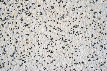 modern white and black gravel wall or empty stones with cement table on top view and rough surface concrete floor for interior or vintage exterior construction decor to texture background or wallpaper
