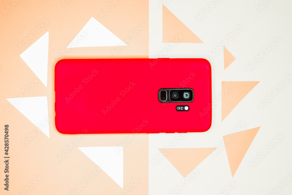 Aufkleber top view of a red mobile phone on a white surface surrounded by triangles