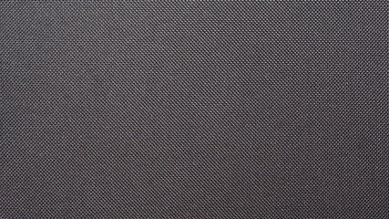 Fototapeta na wymiar Texture of black synthetic fabric, Dark color tone of cloth pattern, Wallpaper background