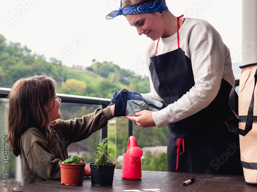 Happy Mother's Day! child daughter plants flowers together with her mother on vacation.