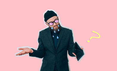 Male hipster entrepreneur lost his business and shows an empty wallet. He has no money to live on....