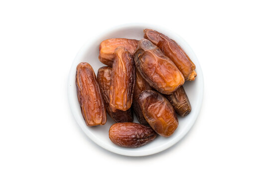 Piles of dates isolated on white