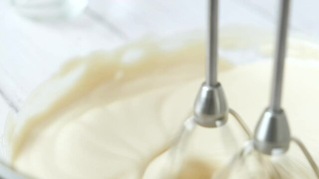 pastry chef use handmixer mixing meringue for cake and bakery.