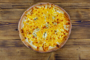 Pizza Four cheese on a wooden background. Top view