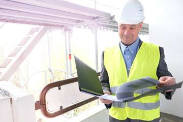 experienced elderly construction worker, construction crew chief, construction engineer in white helmet protection inspecting at construction site for building renovation, civil engineering concept