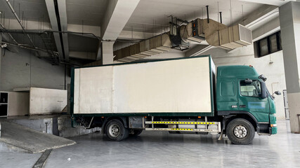 Container truck unloading and loading items at commercial places in middle east