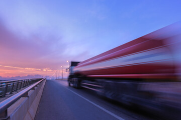 Blurred motion truck on the road with Sunset
