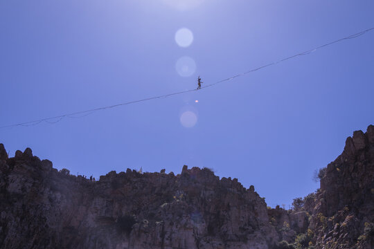 Acrobatics on a tightrope over a crater 55meters high at Lavrio, Greece - Powered by Adobe