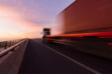 Fototapeta na wymiar Blurred motion truck on the road with Sunset