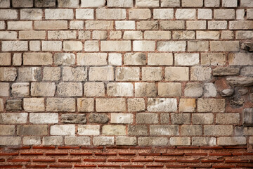 Old wall built of brick and stone, historic background