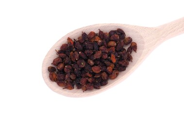 Dried sea buckthorn berries in wooden spoon isolated on white