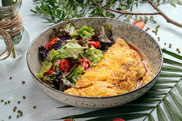 Side view on rustic omelette with vegetables salad