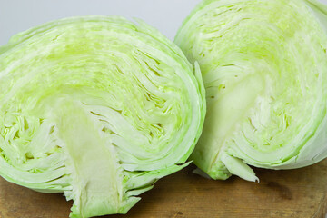 Cabbage on a white background. Cabbage cut in half on a light background. Fresh young cabbage
