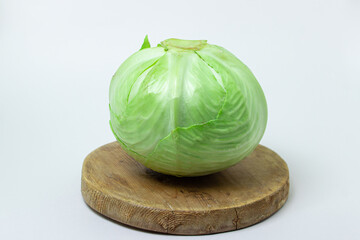 Cabbage on a white background. Head of cabbage on a light background. Fresh young cabbage