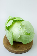 Cabbage on a white background. Head of cabbage on a light background. Fresh young cabbage