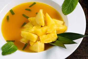 Fresh pineapple dessert recipe with mint orange coulis, hight quality photo