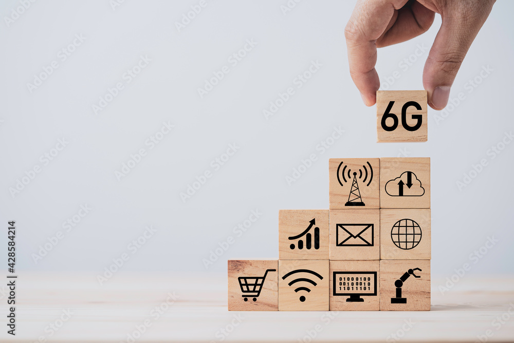 Poster hand putting 6g which print screen on wooden cube block and technology icon , six generation of high