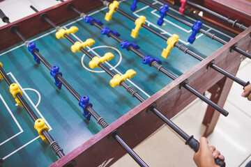 playing foosball table football with friends 