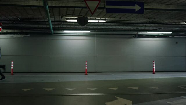 Male criminal running in urban building. Police car with cops following robber