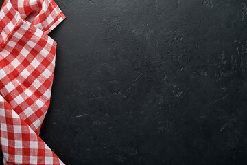Red tablecloth on kitchen table black color with for your recipe or menu. Top view flat lay. Mock...