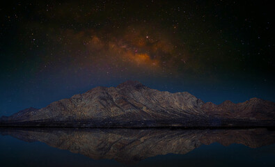 Landscape with Milky Way. Night sky with stars on the mountain
