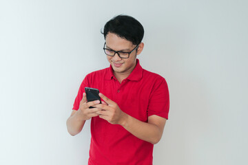 Smart Young asian man is happy and smiling when using smartphone in studio background