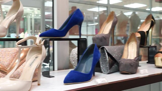 Women's high-heeled shoes and handbags in a shop window