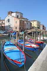 Fototapeta na wymiar three blue wooden boats in the canal Chioggia, Italy