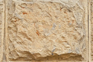 Plaster on a yellow wall. Concrete wall texture close up.