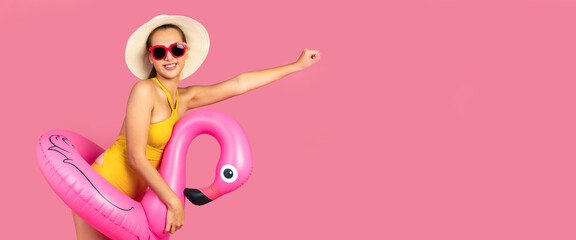 Beautiful, Sexy asian woman in  bikini and smiling standing on pink background isolated .Summer vocation happy trip concept.