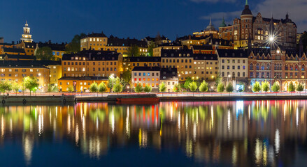 Fototapeta premium Stockholm. Old city embankment with glowing lanterns at sunset.