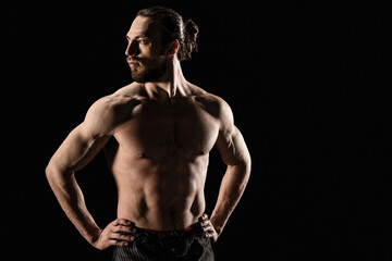 Portrait of athletic man on black background